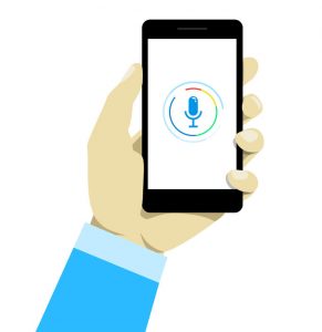 hand holding mobile smart phone with voice control technology.