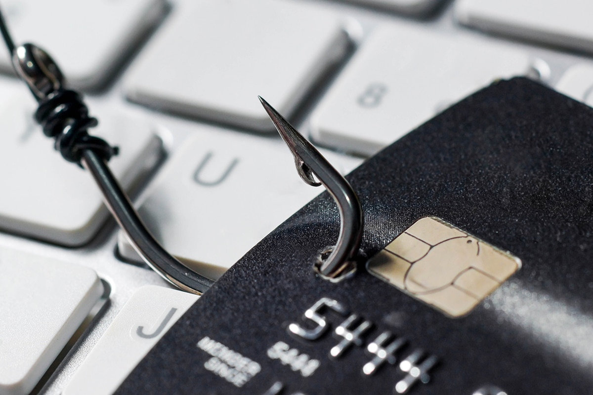 credit card being hooked by a fishing hook illustrating phishing that is done by hackers