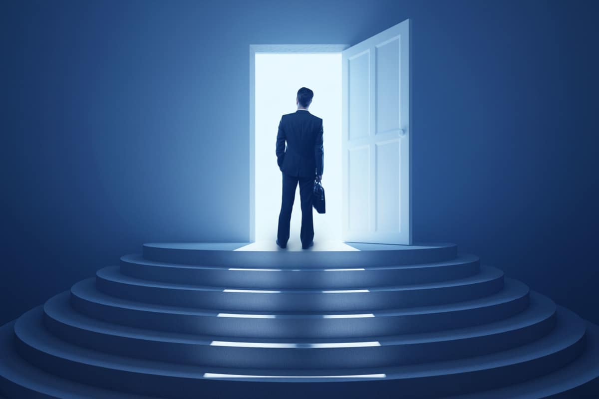 a business owner standing at a doorway with light shining through it illustrating a doorway to success